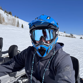 the considered team member on a snowmobile